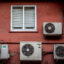 Air conditioning units on the exterior of a residential apartment building in Barcelona, Spain, on Thursday, July 29, 2021. Credit: Angel Garcia/Bloomberg via Getty Images