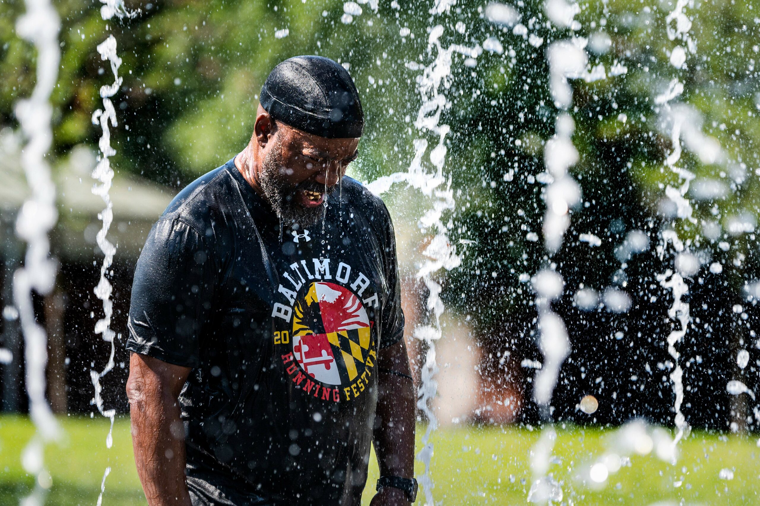 As climate change brings record heat to U.S. cities and Baltimore residents try their best to stay cool, the state of Maryland works to meet its own ambitious emissions reduction goals to help counter the climate crisis. Credit: Jim Watson/AFP via Getty Images.