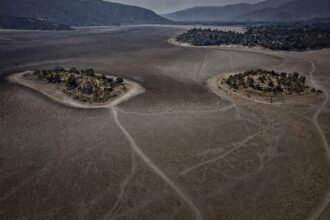 Two patches of land sit in a dried up lake bed in 2022. These were once islands in Laguna de Aculeoa, a popular freshwater lake for fishing, boating and swimming, just an hour from Santiago, Chile. The lake dried up completely in 2018 due to the ongoing megadrought.