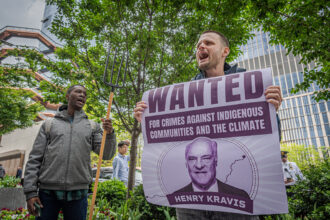 Activists at a protest in New York City, where six people were arrested for blocking the entrance at KKR's headquarters on April 26, 2023.
