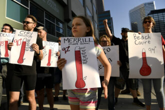Students, teachers and community supporters in Denver held up signs in 2019 as they took part in a protest outside of the Denver Public Schools administration building to demand equity for students attending classes in excessively hot classrooms. Credit: Helen H. Richardson/The Denver Post.
