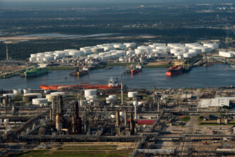Oil tanks and and oil refinery across from each other along side the Houston Ship Channel in Houston, Texas on Sept. 29, 2014. Credit: Ken Cedeno/Corbis via Getty Images