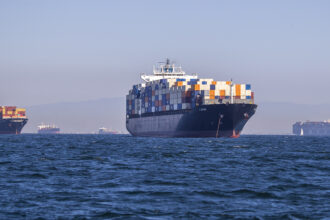 Container ships siting off the coast of the Ports of Los Angeles and Long Beach, waiting to be unloaded. Credit: Allen J. Schaben/Los Angeles Times via Getty Images