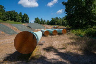 Sections of steel pipe of the Mountain Valley Pipeline lie on wooden blocks on Aug. 31, 2022 in Bent Mountain, Virginia. Credit: Robert Nickelsberg/Getty Images