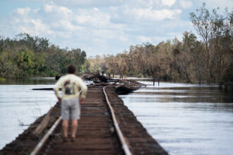 In Arcadia, Florida, Mac Martin looks at flooding along the railroad tracks at the Peace River in October 2022 in Arcadia, nearly a week after Hurricane Ian made landfall on the gulf coast. The Everglades to Gulf Conservation Area would include the watersheds of the Peace River and shore up protection for a region that suffered heavy damage from the hurricane. Credit: Sean Rayford/Getty Images.