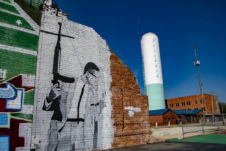 A mural of Malcolm X stands in Prichard, Alabama, near the offices of Prichard Water. Credit: Lee Hedgepeth/Inside Climate News.