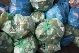Refuse bags full of materials for recycling in different colored plastic bags. Credit: In Pictures Ltd./Corbis via Getty Images