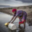 A refugee from Democratic Republic of Congo, collects water for their vegetable crops at a water pan in Kalobeyei settlement for refugees in Turkana County, Kenya on October 2, 2019. Credit: Luis Tato/AFP via Getty Images