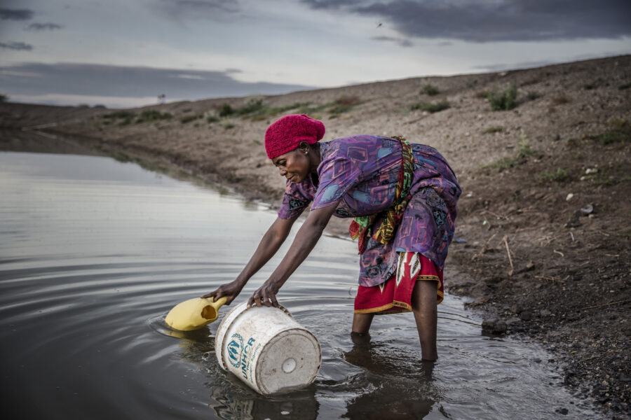 A refugee from Democratic Republic of Congo, collects water for their vegetable crops at a water pan in Kalobeyei settlement for refugees in Turkana County, Kenya on October 2, 2019. Credit: Luis Tato/AFP via Getty Images