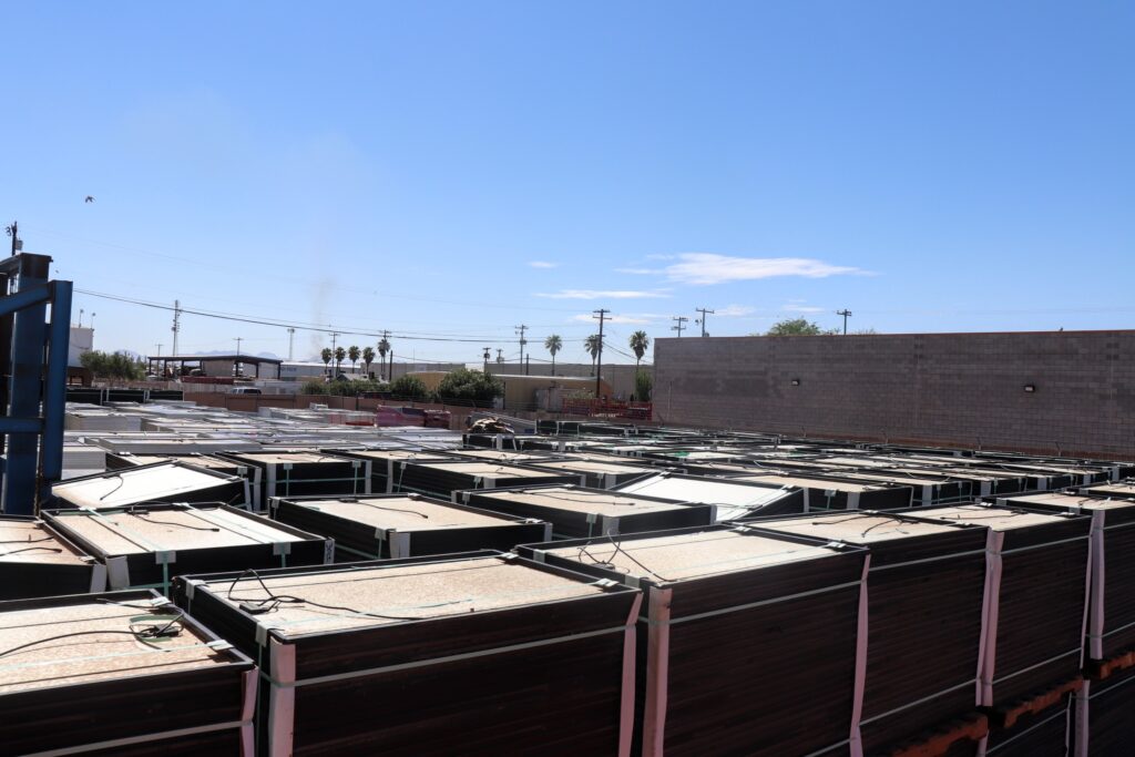 Stacks of solar panels wait to begin the recycling/reuse process at We Recycle Solar in Yuma, Arizona, on August 8, 2023. Credit: Emma Peterson.