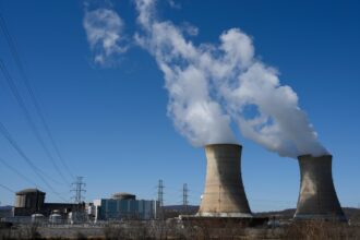 Power lines come off of the nuclear plant on Three Mile Island, with the operational plant run by Exelon Generation on the right, in Middletown, Pennsylvania on March 26, 2019. Credit: Andrew Caballero-Reynolds/AFP via Getty Images