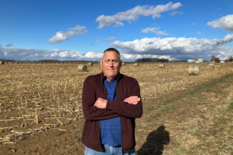 Mark Schein stands at the edge of a field last week, a few miles from his farm in Pickaway County, Ohio. Credit: Dan Gearino